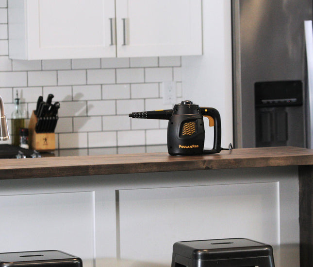 Poulan Pro PP230 side angle on top of a wooden countertop with white cabinetry underneath.