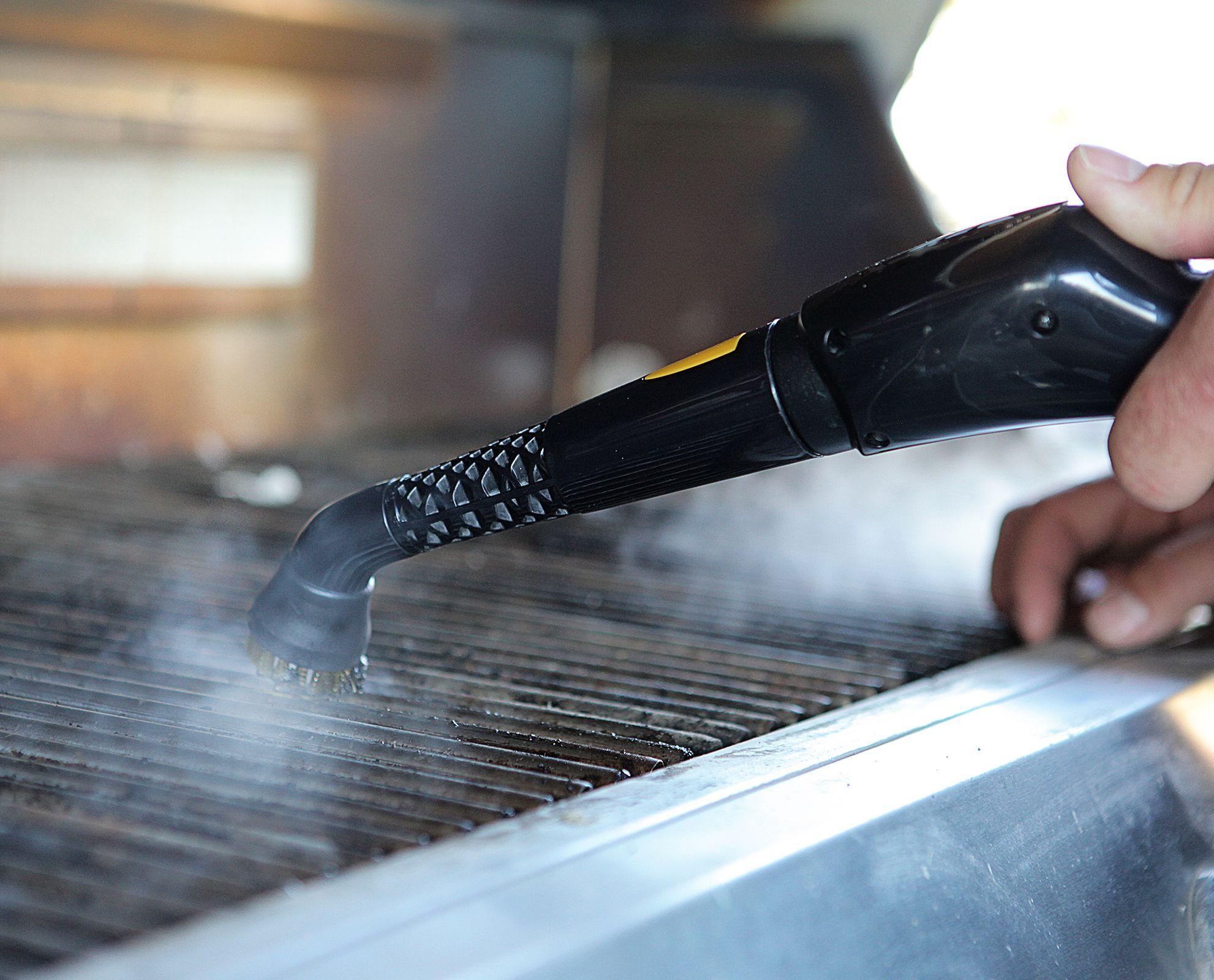 Image of the PP330 steam cleaner being used on a dirty grill highlighting the features of a Brass brush head getting the tough grease off, and the simple nozzle that the brush head is attached too, and the simplicity of use.