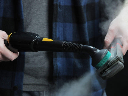 Image of the PP330 steam cleaner being used on a rusty wrench highlighting the features of a scrubbing brush head, and the simple nozzle that the brush head is attached too, and the simplicity of use.