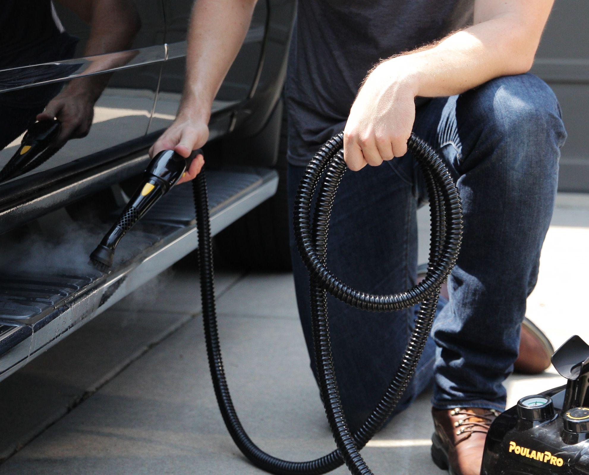 Image of the PP350 steam cleaner being used on a running board of a large vehicle highlighting the features of a regular brush head as well as length of hose as well as simplicity of use.
