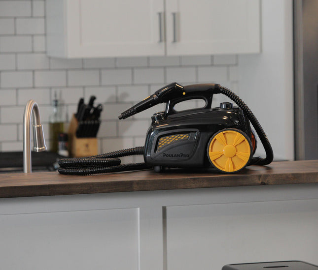 The Poulan Pro PP350 side angle on top of a wooden countertop with white cabinetry underneath.