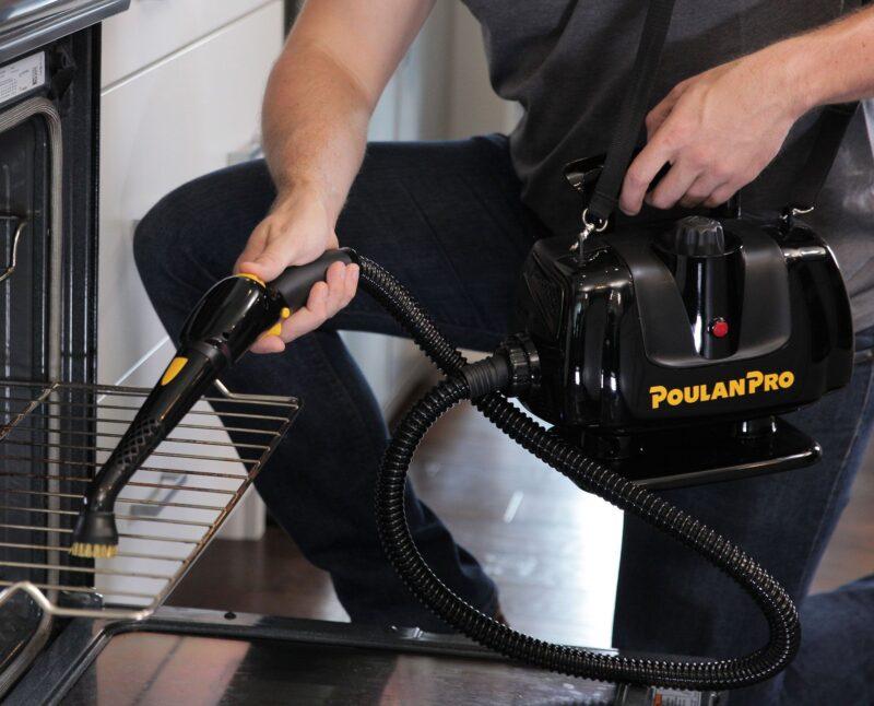 Man using a Poulan Pro PP270 Portable Power Steam Cleaner on an oven rack